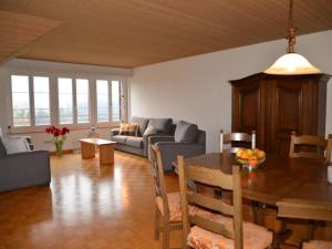 a living room with a table and a couch at Apartment Sunnebad Sternenberg by Interhome in Sternenberg