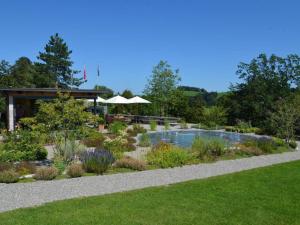 a garden with a swimming pool in the middle at Apartment Sunnebad Sternenberg by Interhome in Sternenberg