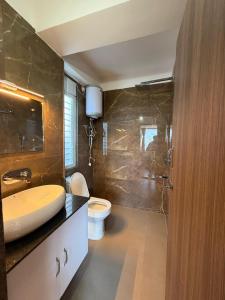 a bathroom with a sink and a toilet at Royale Serenity in Gangtok +30 photos