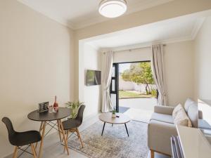 a living room with a couch and a table at Catalyst Guest House in Cape Town