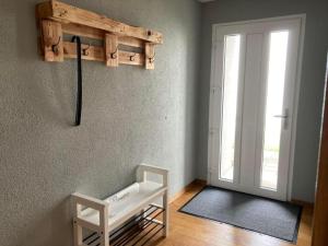 a room with a white bench next to a door at Apartment Seehof by Interhome in Rorschacherberg