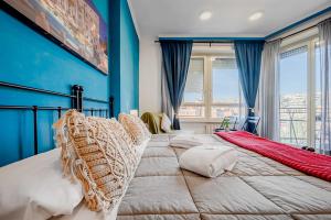 a bedroom with a large bed with a blue wall at Domus Antica Trastevere in Rome