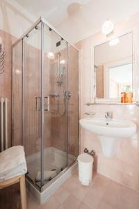 a bathroom with a shower and a sink at Hotel Oasi in Cortina dʼAmpezzo +110 photos