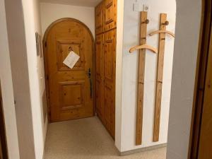 a hallway with a wooden door in a room at Apartment Wohnung Grün by Interhome in La Punt-Chamues-ch +34 photos