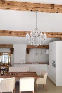 a kitchen with a dining table and a chandelier at Apartment Alpenchic SpycherHus by Interhome in Klosters