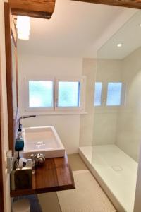 a bathroom with a white sink and a window at Apartment Alpenchic SpycherHus by Interhome in Klosters