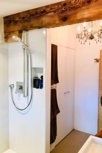 a bathroom with a shower and a sink at Apartment Alpenchic SpycherHus by Interhome in Klosters