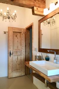 a bathroom with a large sink and a mirror at Apartment Alpenchic SpycherHus by Interhome in Klosters