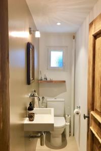 a bathroom with a white toilet and a sink at Apartment Alpenchic SpycherHus by Interhome in Klosters +13 photos