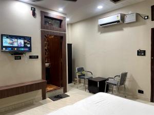 a hospital room with a bed and a tv on the wall at Indian Happy Homes in Siar