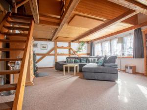 a living room with a couch and a staircase at Apartment Hof Bommes by Interhome in Gais