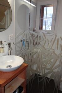 a bathroom with a white sink and a shower at Apartment Hof Bommes by Interhome in Gais