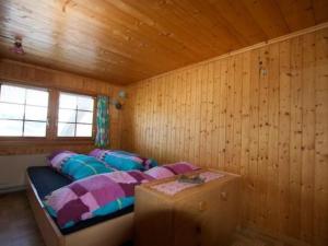 a bedroom with a bed in a wooden room at Apartment Hasenbüel by Interhome in Ricken +28 photos