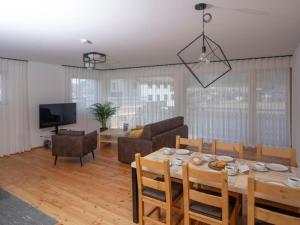 a dining room and living room with a table and chairs at Apartment Duai by Interhome in Müstair