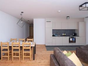 a kitchen and dining room with a table and a couch at Apartment Duai by Interhome in Müstair +9 photos