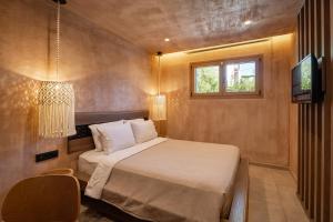 a small bedroom with a bed and a window at Salud Ierissos in Ierissos