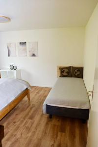 a bedroom with a bed and a wooden floor at Apartment Panoramablick by Interhome in Nesslau +16 photos
