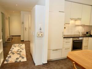 a kitchen with white cabinets and a table in a room at Apartment Panoramablick by Interhome in Nesslau
