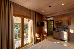 a bedroom with a bed and a large window at Salud Ierissos in Ierissos