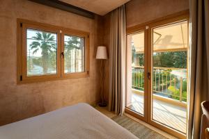 a bedroom with a bed and a large window at Salud Ierissos in Ierissos