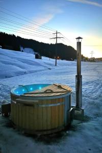 a hot tub in the snow next to a street light at Apartment Bädli by Interhome in Wildhaus