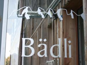 a sign on the side of a building with birds on it at Apartment Bädli by Interhome in Wildhaus