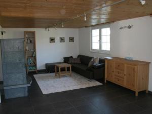 a living room with a couch and a table at Apartment Bädli by Interhome in Wildhaus +15 photos