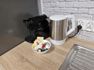 a coffee maker and a cup on a counter at Central Platinum Apartments 5 Studio z aneksem kuchennym i tarasem in Rybnik