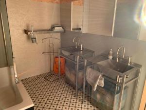 a kitchen with two sinks and a tiled floor at Apartment nirkwerk by Interhome in Schönengrund