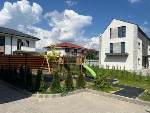 a playground in a yard next to a house at Davids place 2 in Floreşti