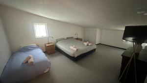 a bedroom with two beds with towels on them at Maison - La Bourdine in Montreuil +5 photos