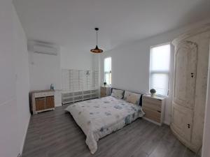 a bedroom with a large bed in a white room at The Heritage Roches Noires in Roches Noires +13 photos