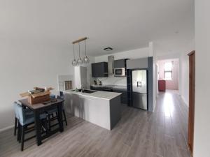 a kitchen with a counter and a table in it at The Heritage Roches Noires in Roches Noires