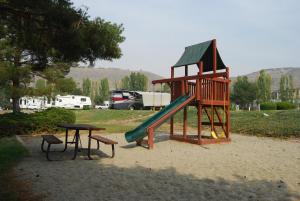 a playground with a slide and a bench and a table at Crescent Bar Camping Resort Studio Cabin 2 in Trinidad