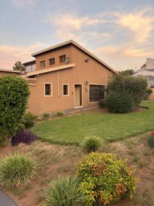 a house in a yard with a grass yard at Swakhanya Haus in Vereeniging