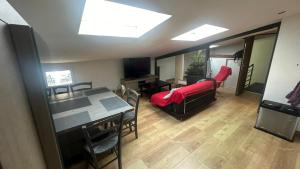 a living room with a couch and a dining room at Maison - La Bourdine in Montreuil