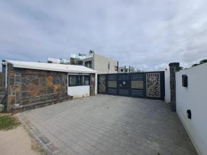 a driveway with a gate and a building at The Heritage Roches Noires in Roches Noires