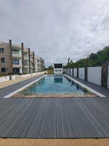 a large swimming pool with a building in the background at The Heritage Roches Noires in Roches Noires