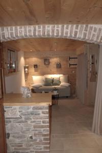 a living room with a couch and a table at LA VARNACHE logement cosy in Bonvillard
