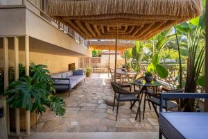 an outdoor patio with tables and chairs and plants at Salud Ierissos in Ierissos