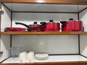 a group of pots and pans on a shelf at Nasma Homes Al Dana in Abu Dhabi +7 photos