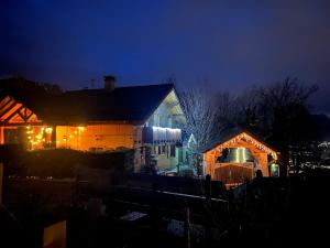 a house with christmas lights on it at night at LA VARNACHE logement cosy in Bonvillard