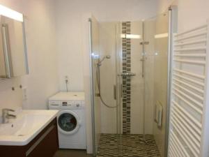 a bathroom with a shower and a washing machine at Apartment Gill by Interhome in Stelle