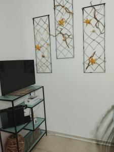 a room with three stained glass windows and a tv at Le stanze di veneranda in Silvi Marina