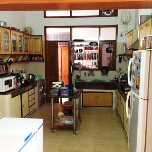 a kitchen with a sink and a refrigerator at Luxurious Homestay- Chandīgarh in Chandīgarh