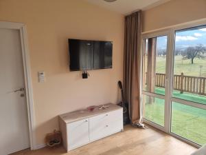 a living room with a flat screen tv on the wall at Villa Nikol Apartment #4 in Raduil