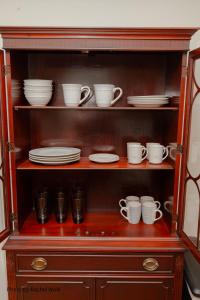 a cabinet filled with dishes and cups and plates at O'Brien's Sanctuary in Candler