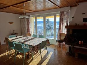 a dining room with a table and chairs and a window at Villa panorama 1000 in La Chaux-de-Fonds