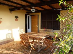 a wooden table and chairs on a patio at Bellevue, country house in Velletri