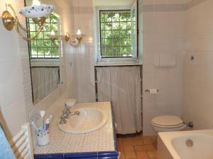 a bathroom with a sink and a toilet and a mirror at Bellevue, country house in Velletri +19 photos